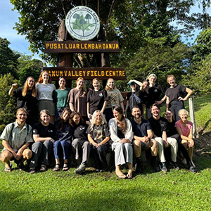 A group of  students in front of a sign reading "Danum Valley Field Centre"