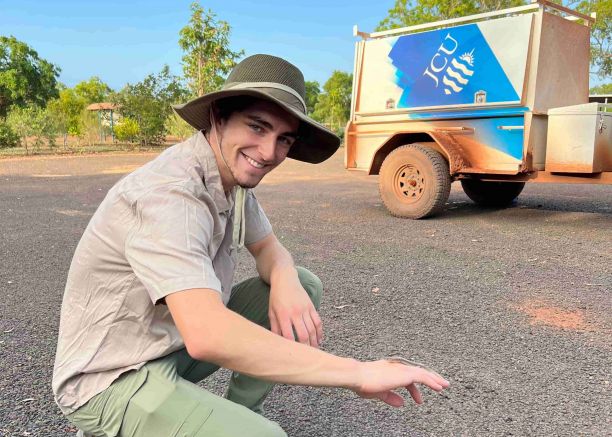  Bachelor of Science student Tomas Cooney smiling with a small lizard on his hand. 