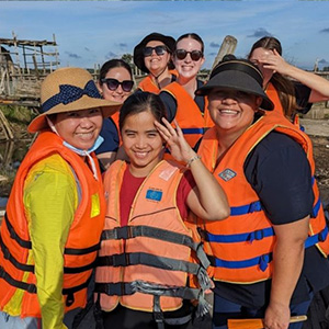 A group of  Nursing students with locals, all wearing high visibility clothing