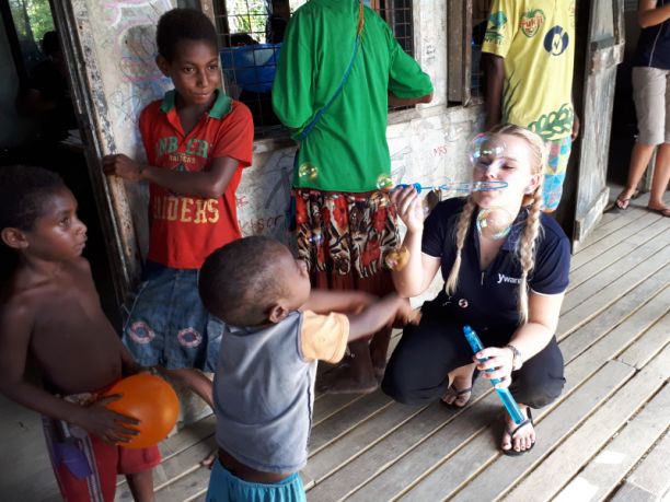 Nursing student playing with Papua New Guinea children