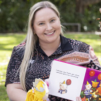  Bachelor of Education (Early Childhood Education) student Tabitha McCann holding a children's picture book. 