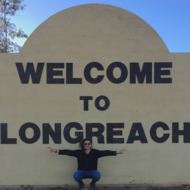  Physio student, Mason in front of the Welcome to Longreach sign