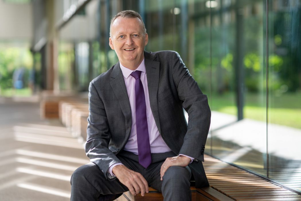  Vice Chancellor and President Professor Simon Biggs seated outside the Education Central Building at the  Townsville, Bebegu Yumba campus, Douglas