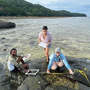Three  students conducting scientific measures in the ocean