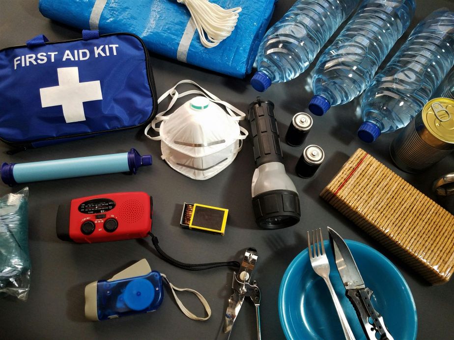 Picture of emergency kit with supplies including medication, water, radio 